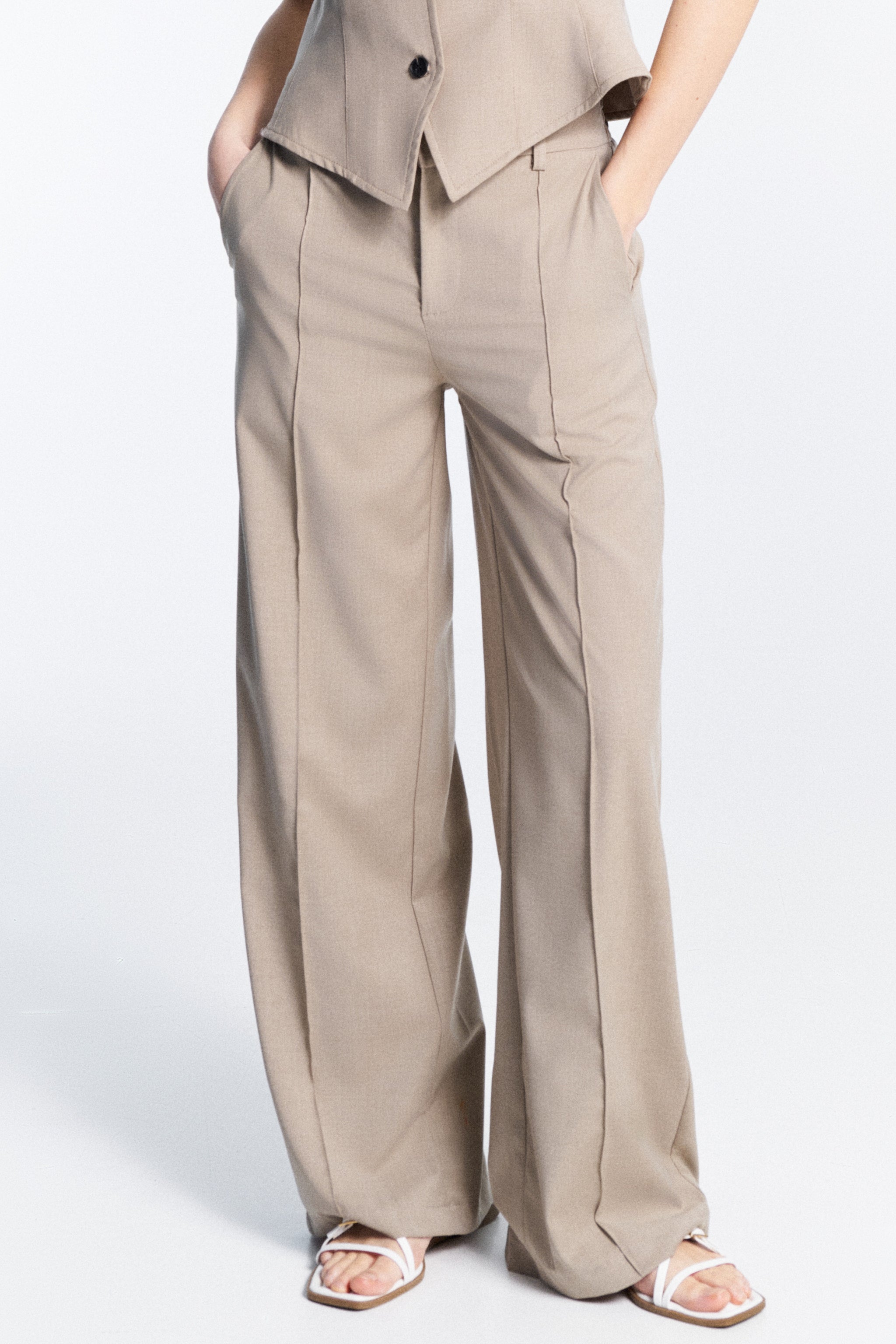 Serena Trousers mud gray high waisted trousers front view with belt loops side pockets and zip hook closure regular fit