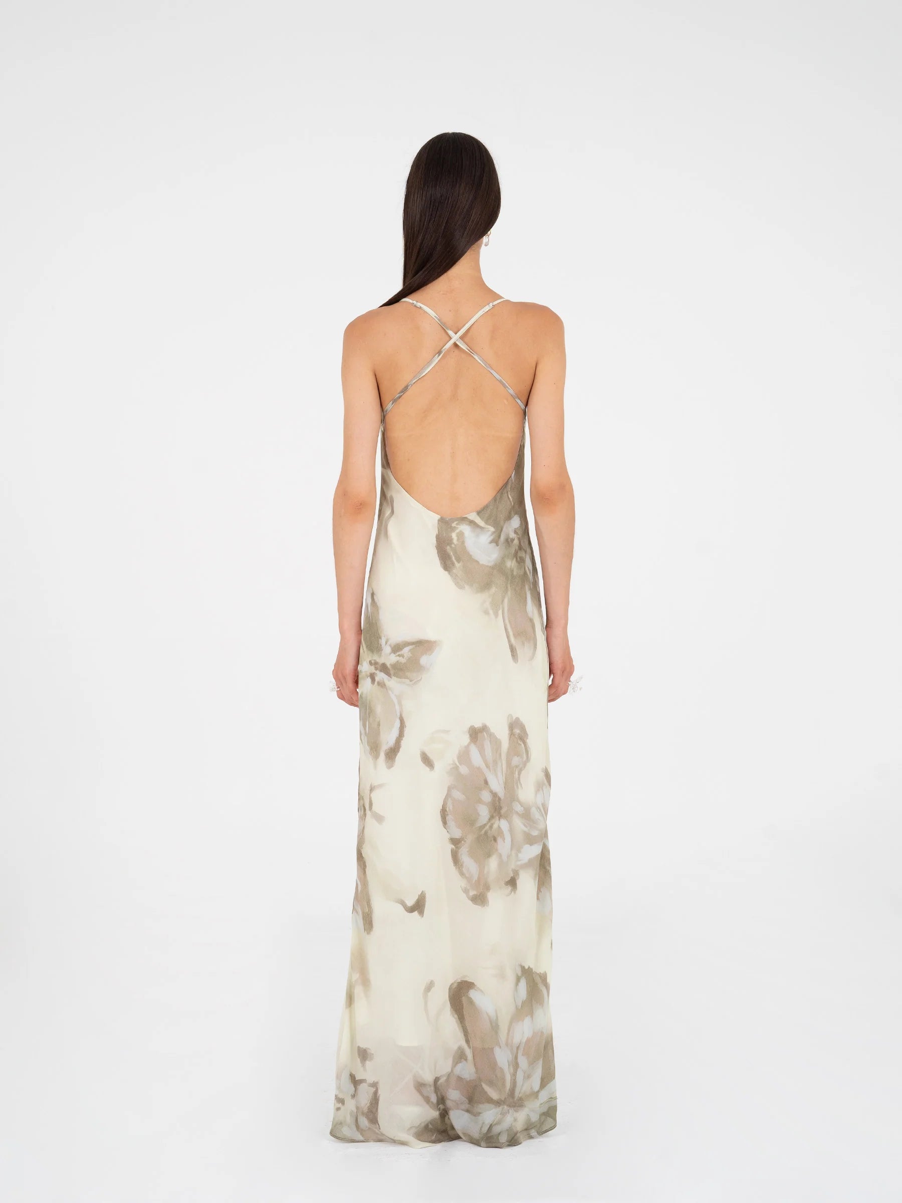 Beige floral printed maxi dress back view featuring open back and crisscross straps lined design