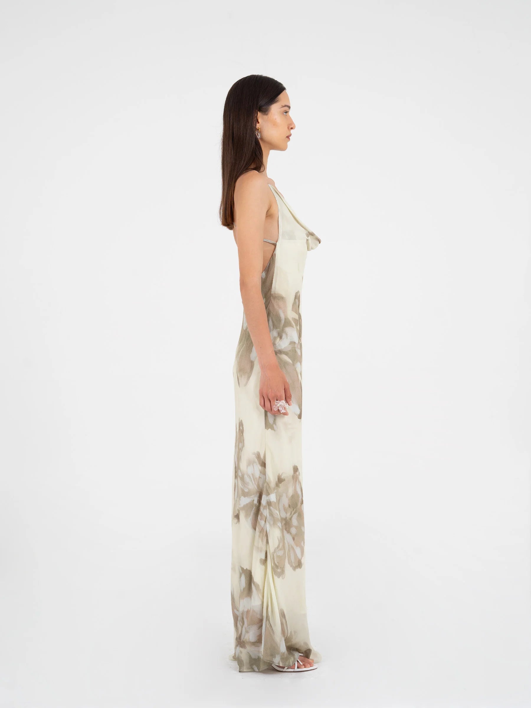 Beige floral printed maxi dress side view highlighting slim silhouette and crisscross back detail