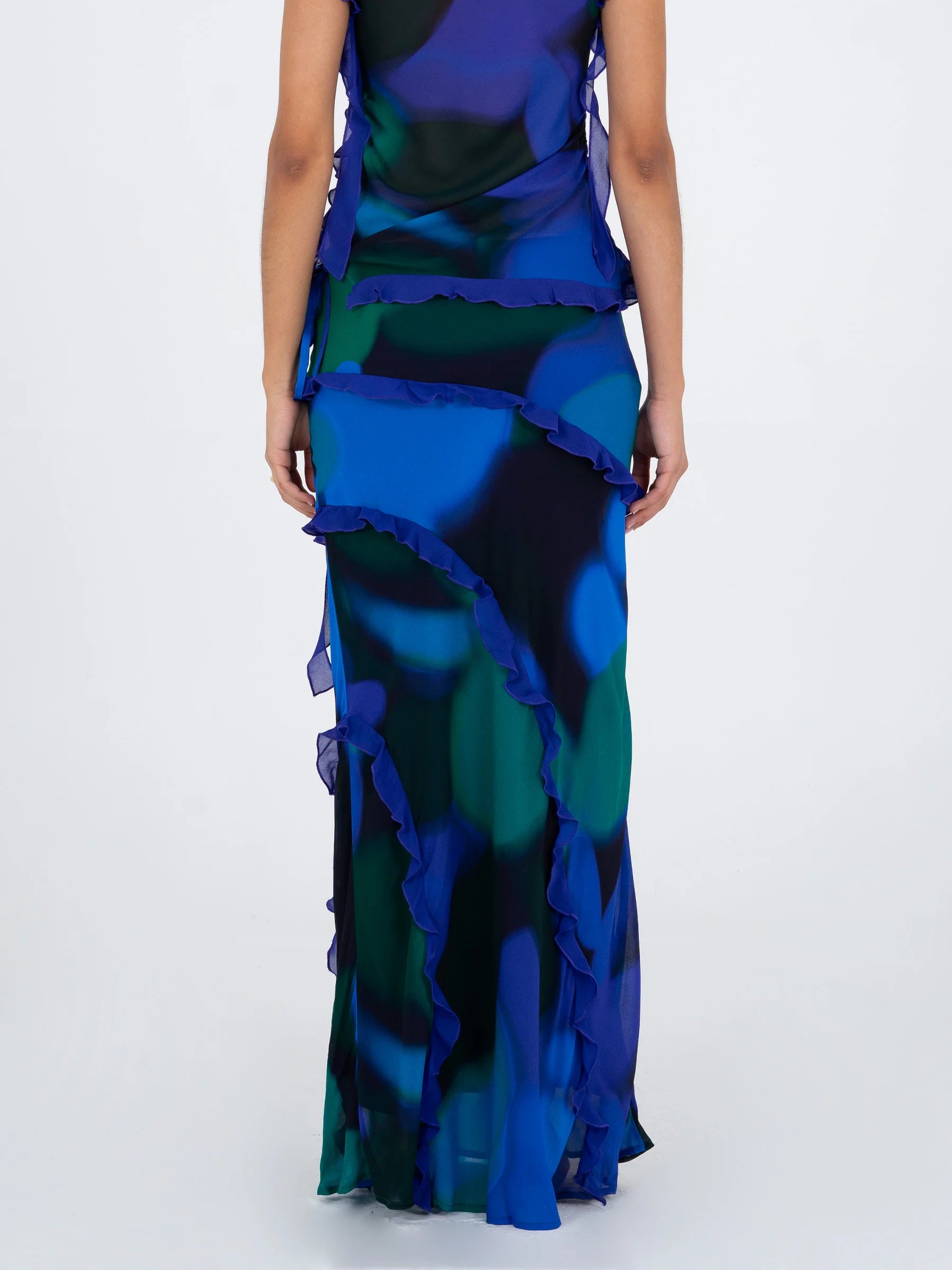 Blue multicolor printed long skirt back view with flowing silhouette and decorative ruffles