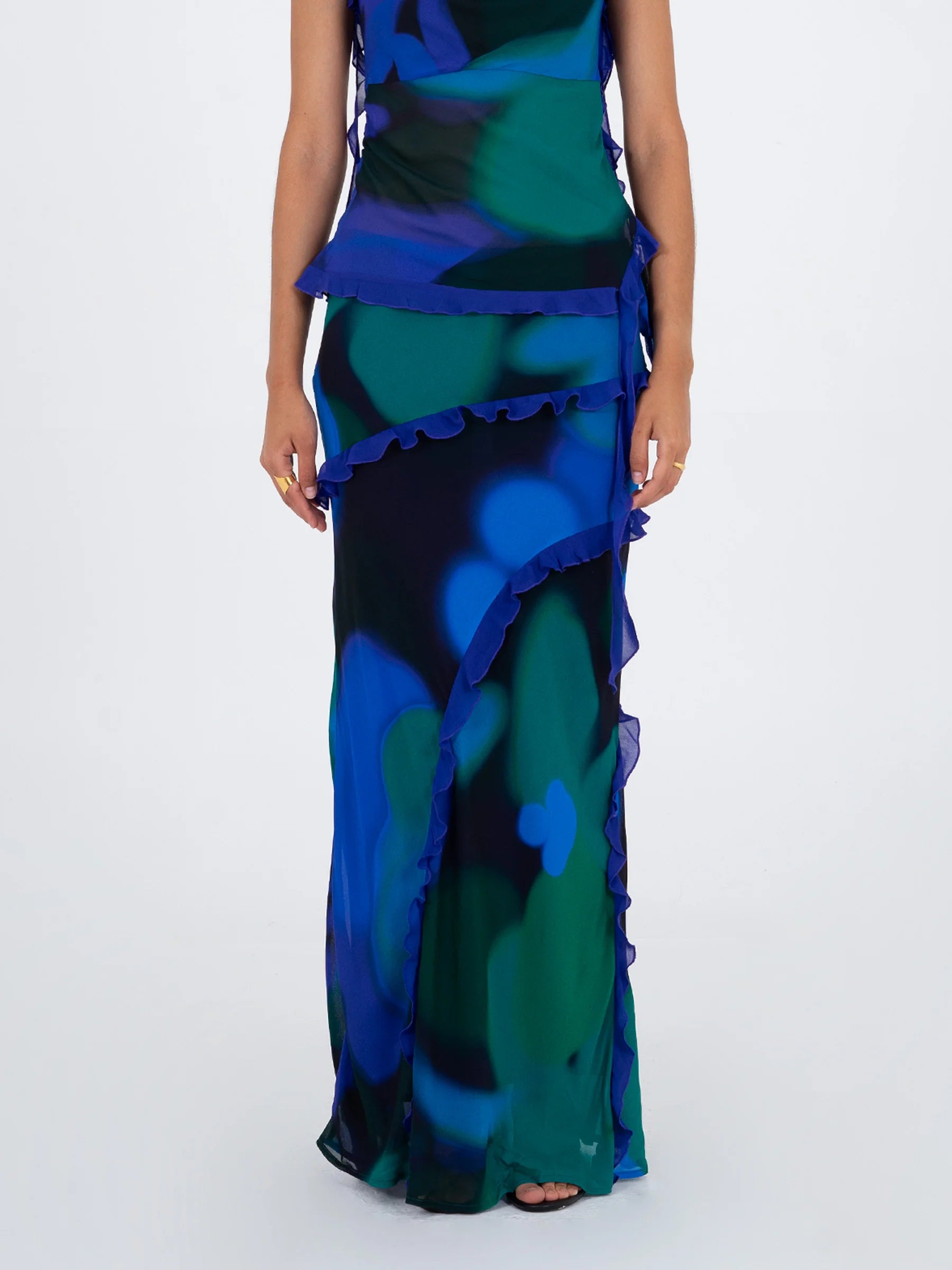 Blue multicolor printed long skirt front view with decorative ruffles and side slit