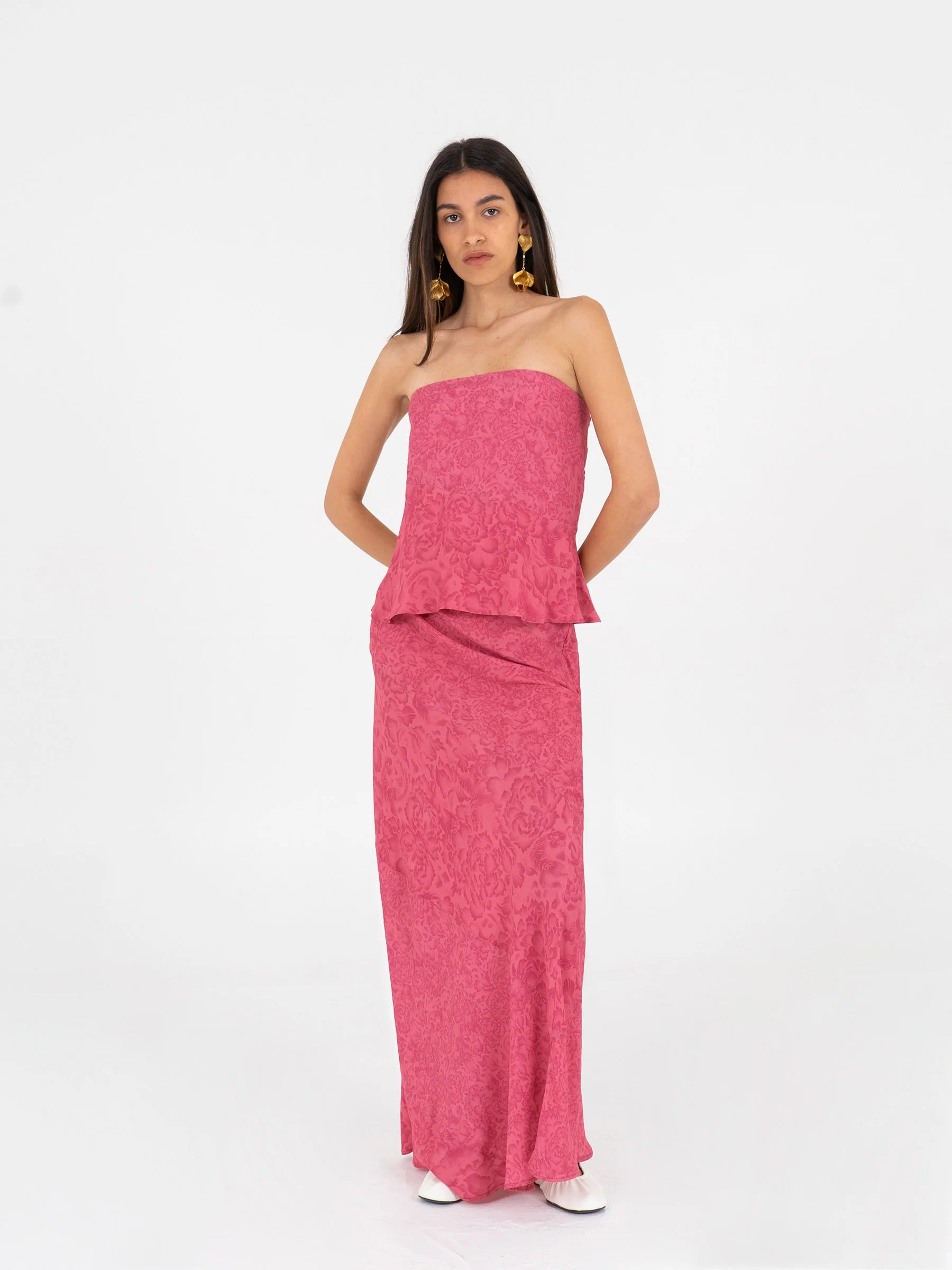 Pink long low rise skirt model pose showing elegant fit invisible side zipper and flowing ecovero viscose texture