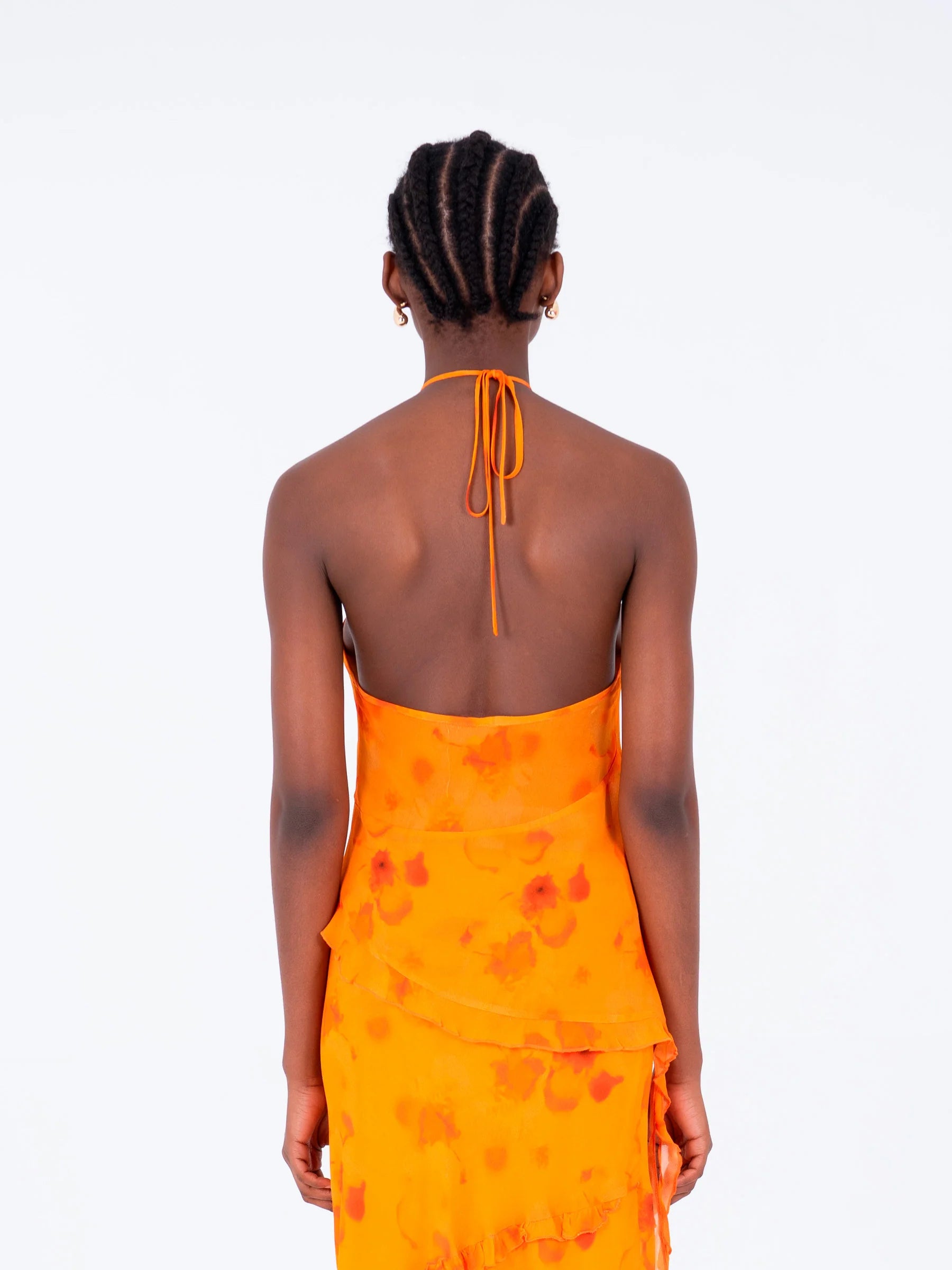 Orange halter neck blouse back view highlighting open back neckline and flowing viscose fabric