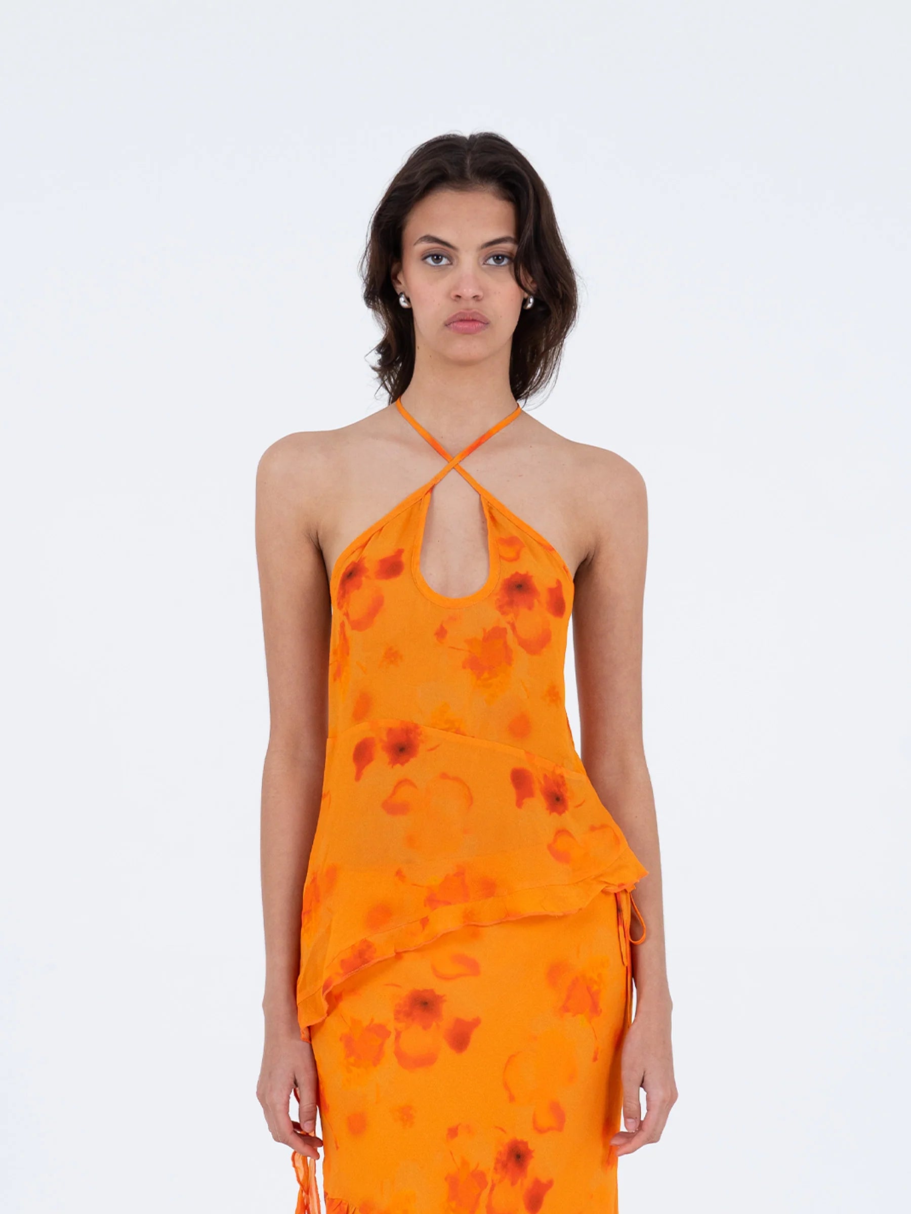 Orange halter neck blouse front view with slit neckline and asymmetrical hem ruffled band