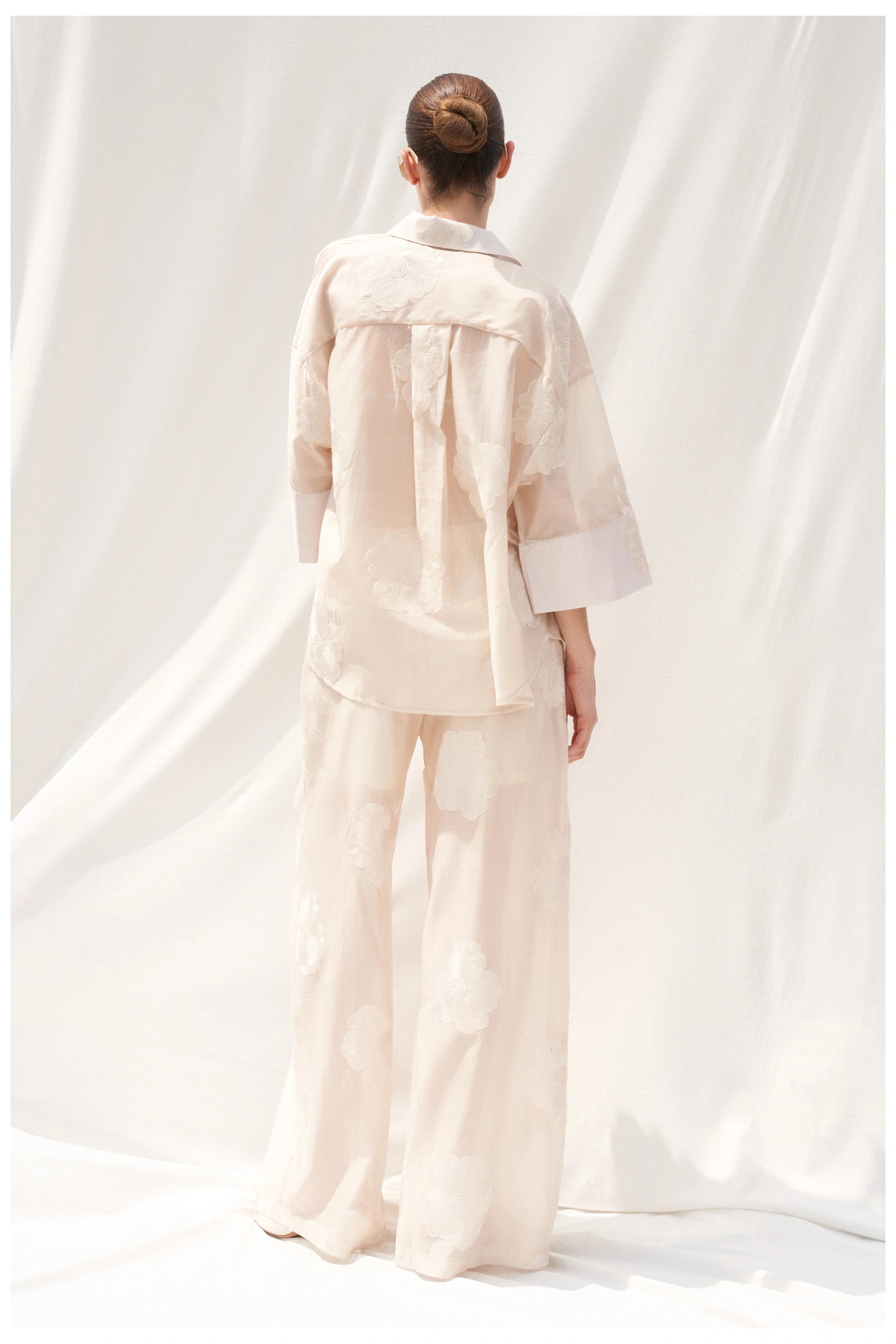 Beige embroidered trousers back view