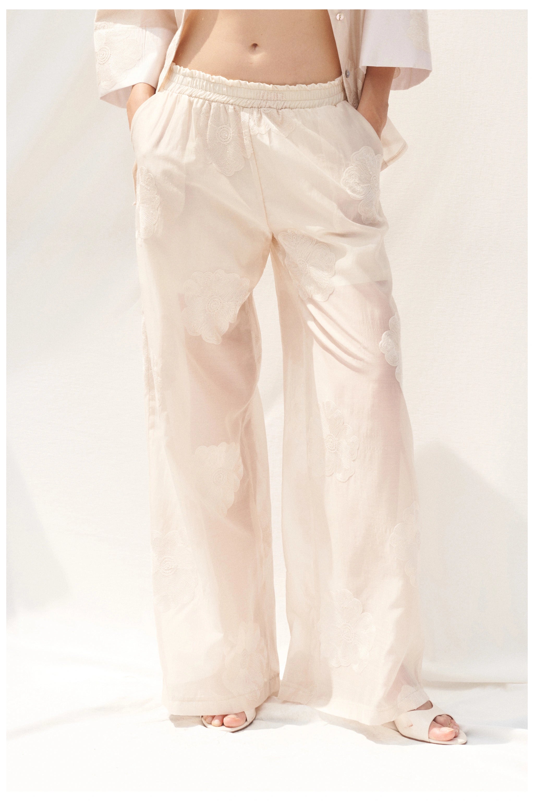 Beige embroidered trousers waist detail view